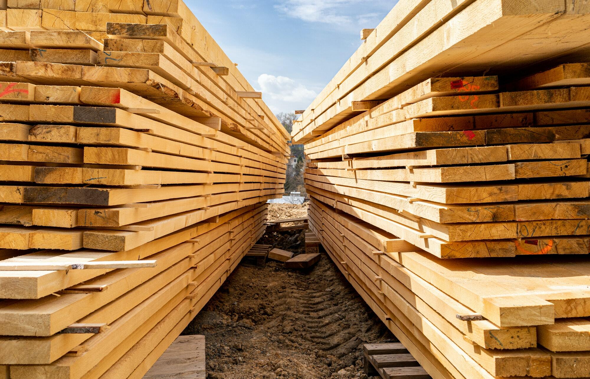 Stack of wooden beams on construction site prepared for building a house