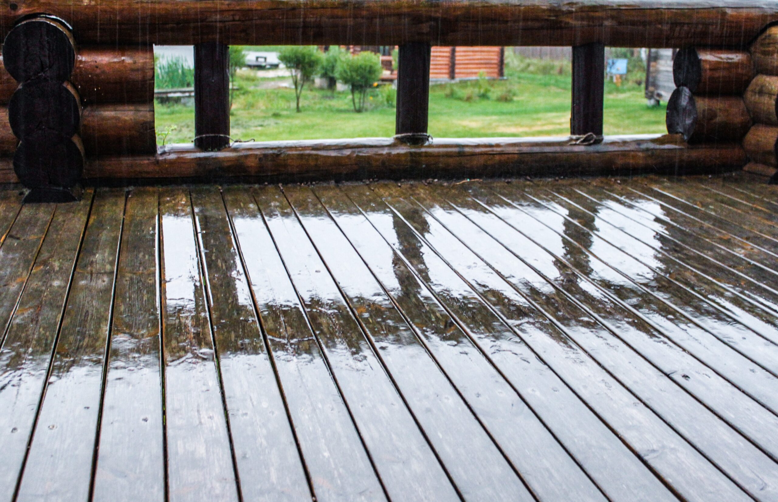 wooden terrace in the rain drops reflecting relaxation empty space house splash weather terrace t20 mLv9pE scaled
